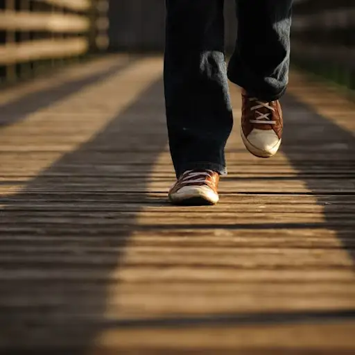 close up of shoes walking on boardwalk