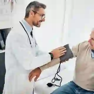 doctor testing patient's blood pressure
