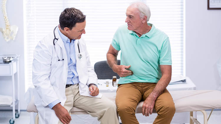 一个男人正在和他的医生讨论胃痛。