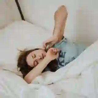 woman stretching in bed