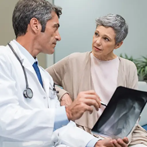 Doctor showing an x-ray to a senior patient.
