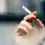 A closeup of a hand holding a lit cigarette