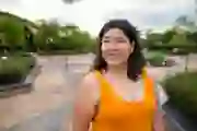A happy woman walks outside