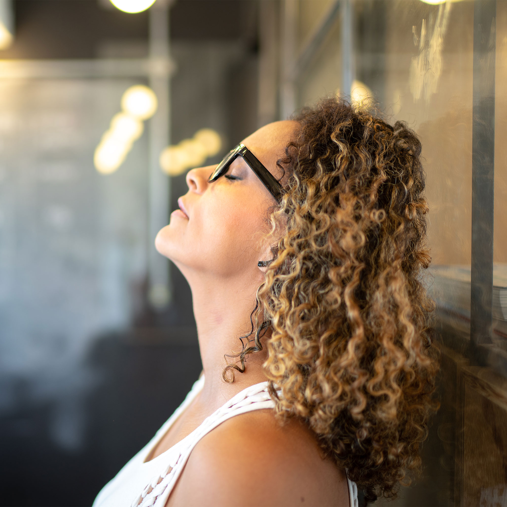 一个疲惫的女人靠玻璃幕墙