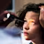 Selective focus of a teen girl looking up as a doctor shines a light while examine her eyes.
