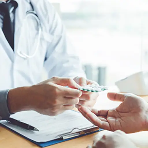 Doctor giving pills