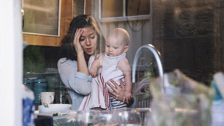 家里有宝宝在厨房里强调年轻的母亲。