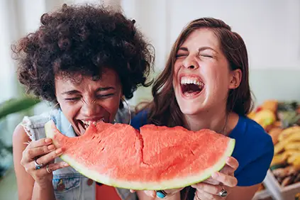 女人们笑着一起吃西瓜
