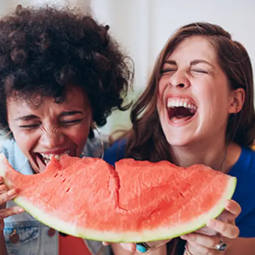 女人们笑着一起吃西瓜