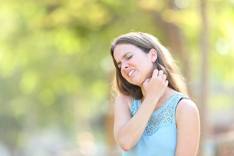 girl scratching neck