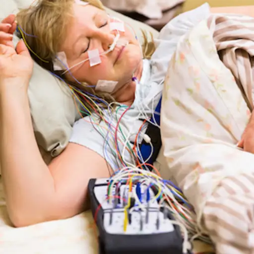 Woman wired for sleep study.