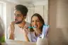 Couple brushing their teeth together