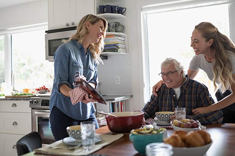 Sisters making dinner for their senior father.