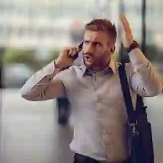 Furious businessman talking to someone over smart phone