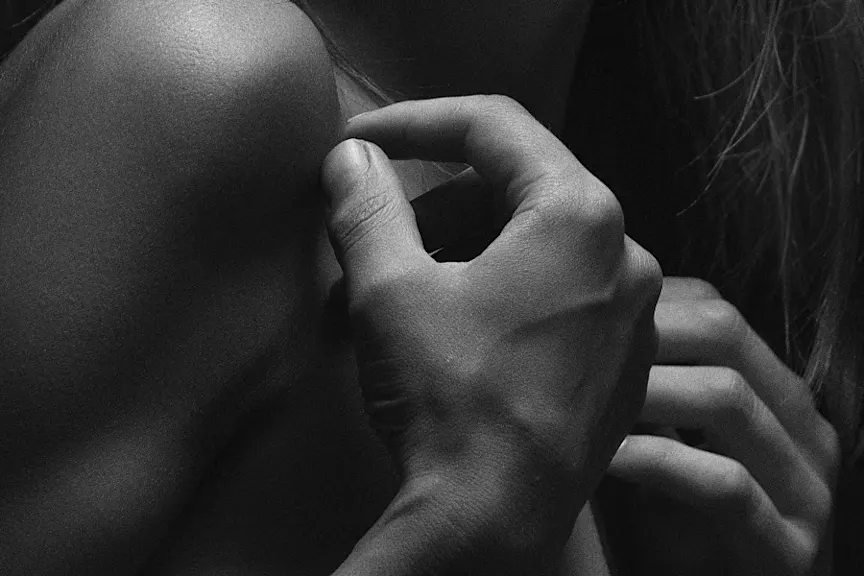 woman scratching shoulder, black and white image
