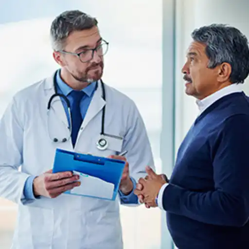 Senior man discussing his risk of leukemia with his doctor.