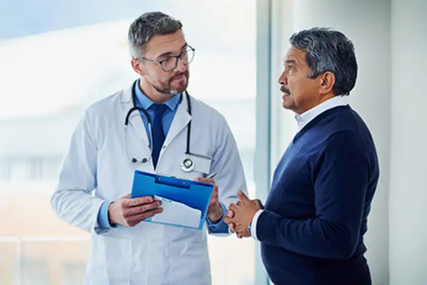 Senior man discussing his risk of leukemia with his doctor.