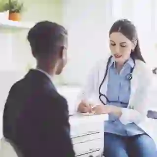Doctor writing a referral for a patient.