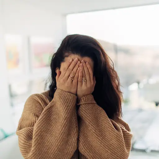 Woman embarrassed of her psoriasis.