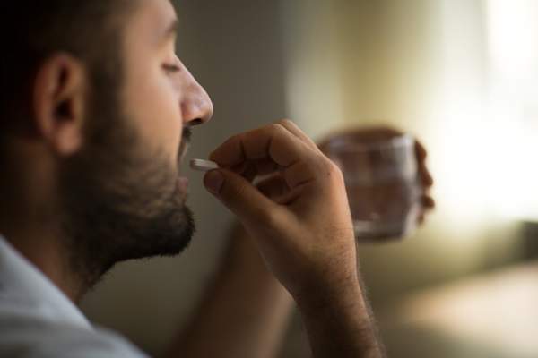 man taking pill