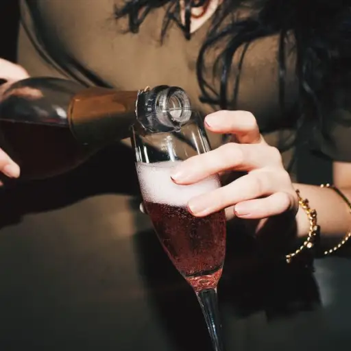 woman pouring champagne