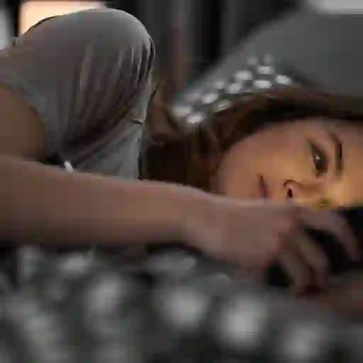 年轻女子在床上看手机