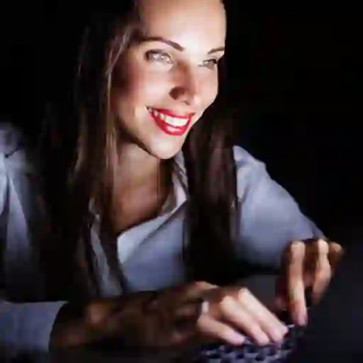 Woman on computer at night.
