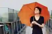 Woman holding an umbrella in the rain.