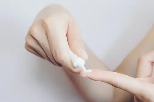 squeezing tube of cream