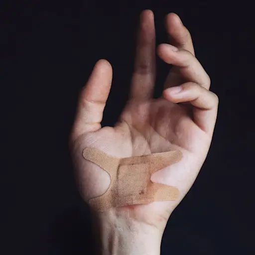 hand with slightly bloody bandaid on palm