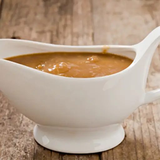 Gravy boat on table.