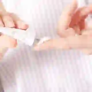 squeezing ointment onto finger