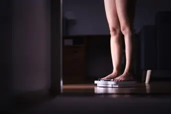 Woman standing on a scale
