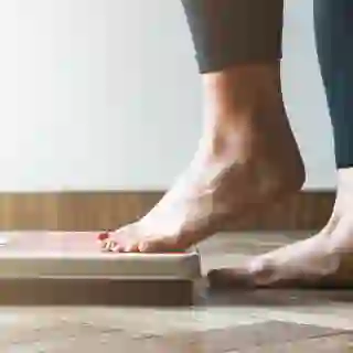 Woman stepping onto bathroom scale