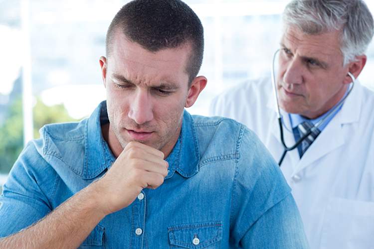 Doctor examining a man with a cough.