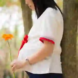 Pregnant woman holding flower