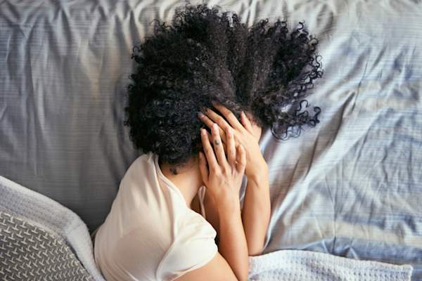 女人在床上盖着脸和头