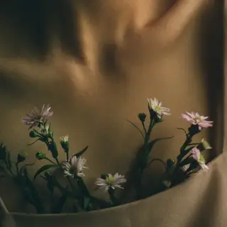 close up of woman's chest with flowers in shirt