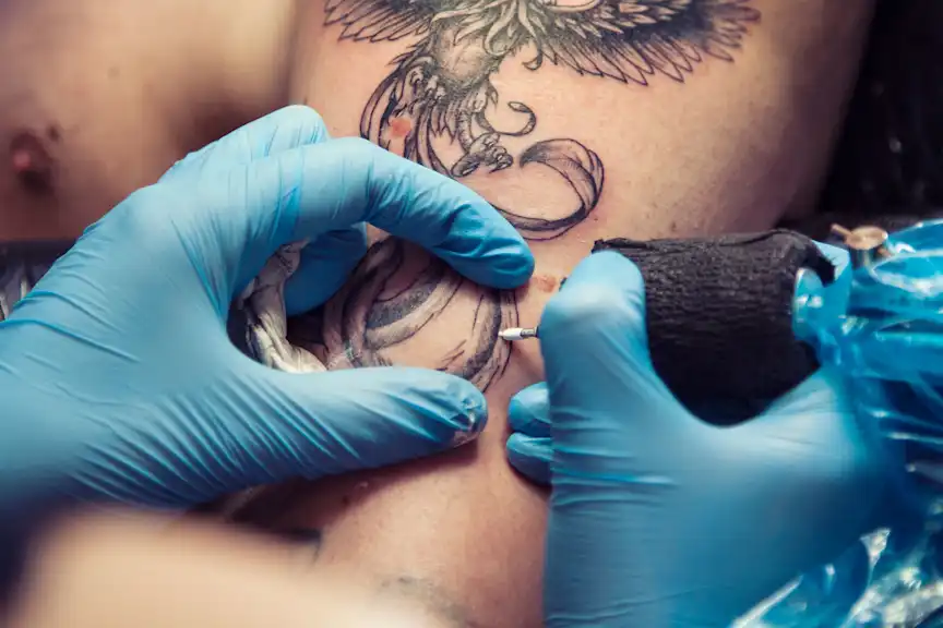 A view of someone getting tattooed around their moles
