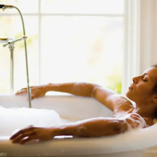 Young woman relaxing in bubble bath.