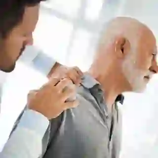 Doctor examining shoulder