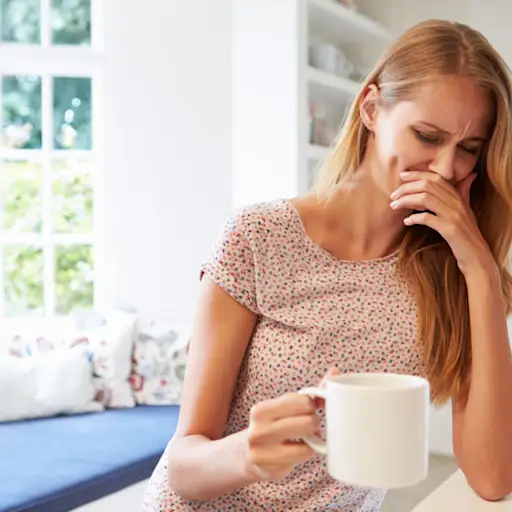 Woman in early stages of pregnancy experiencing morning sickness