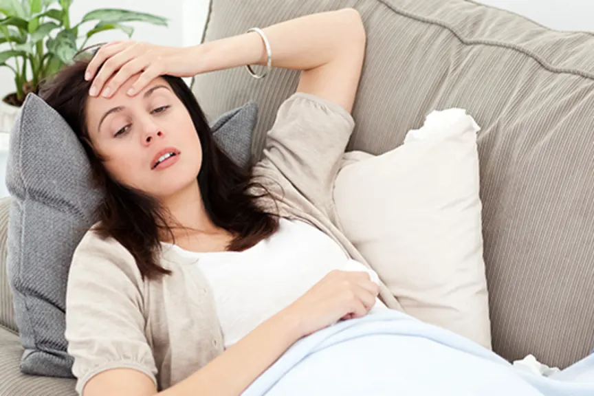 一个女人躺在沙发上经历着戒毒的症状。