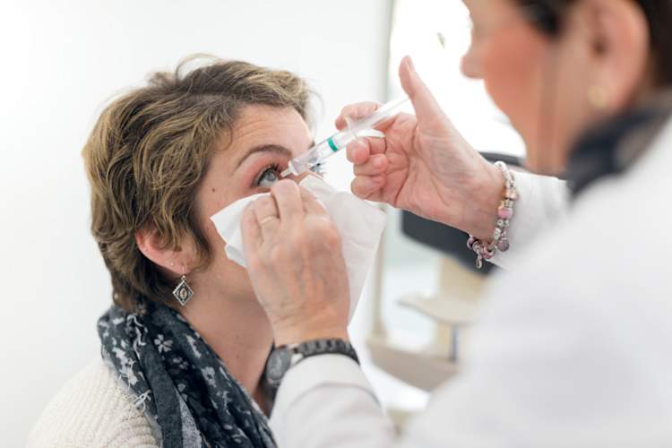 医生投入滴眼液注射前