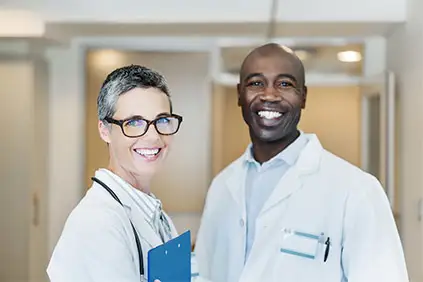 Smiling male doctor and female doctor in hospital.
