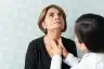 doctor examining thyroid