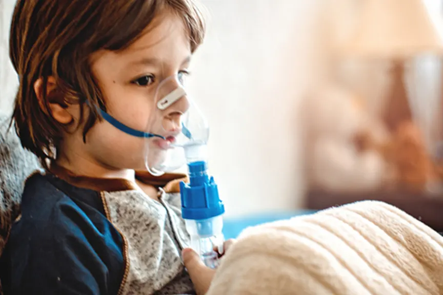 boy using asthma medicine image