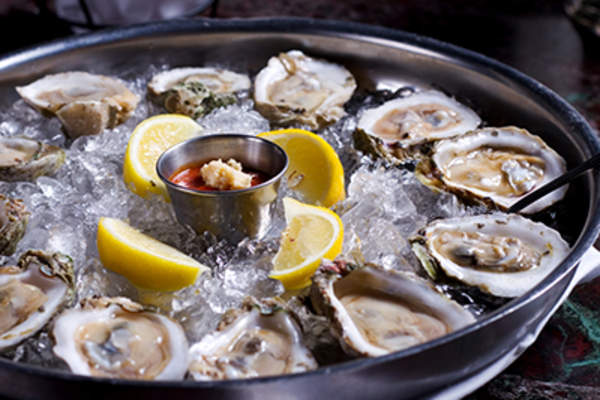 在金属托盘上冰柠檬新鲜生牡蛎