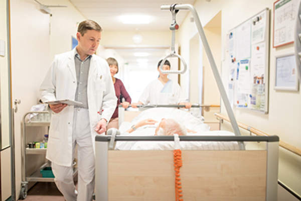 Man talking to his surgeon before surgery.
