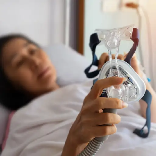 拿着睡眠呼吸暂停面具的妇女,去睡觉